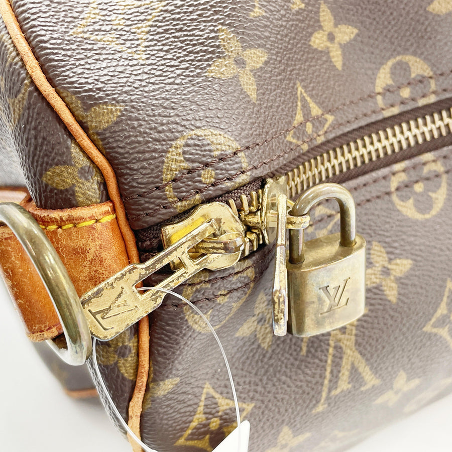 Secondstore Louis Vuitton Keepall 55 monogram canvas travel bag detail showing gold tone zipper and branded padlock