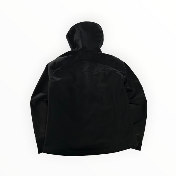 Back view of a black Secondstore C.P. Company Goggle Jacket in recycled nylon soft-shell fabric with a hood.