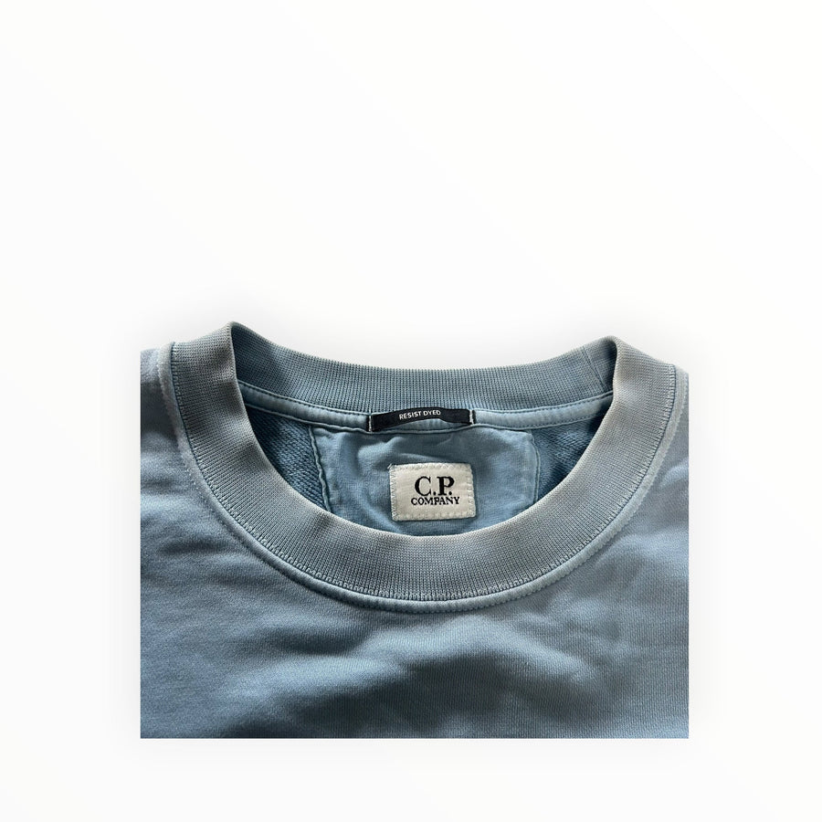 Secondstore C.P. Company crewneck sweatshirt in faded blue cotton with Resist Dyed finish and ribbed collar detail.
