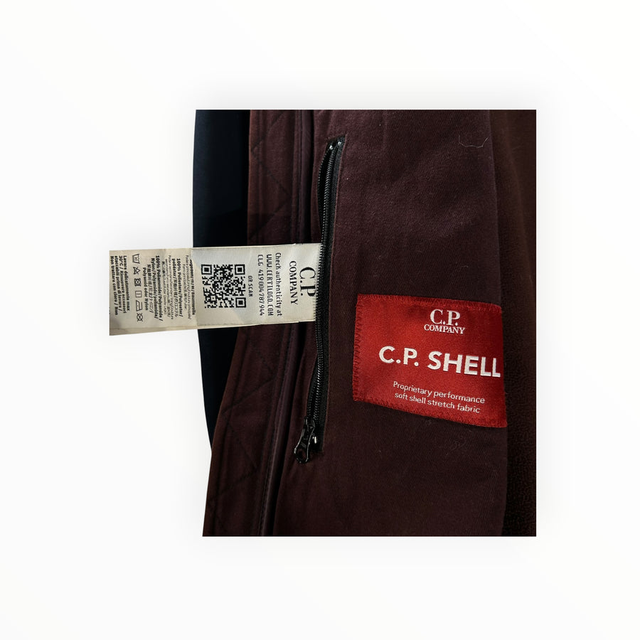 Secondstore C.P. Company Goggle Jacket interior label with C.P. Shell branding and care instructions in burgundy fleece