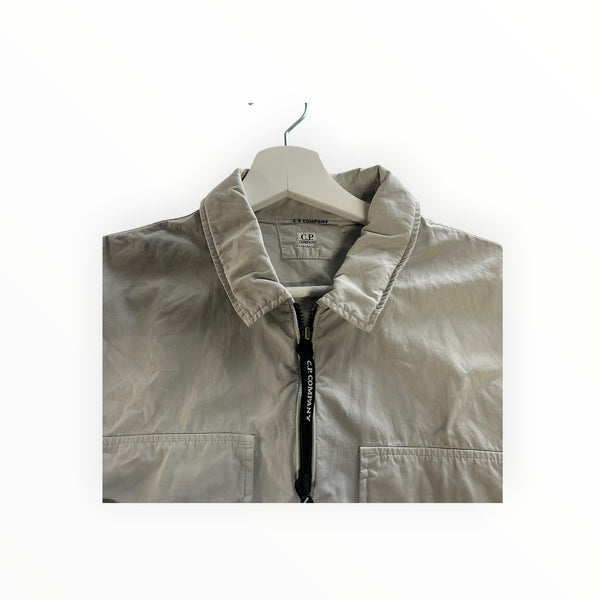 Secondstore C.P. Company light grey zip-up overshirt with a classic collar and branded zipper pull detail.