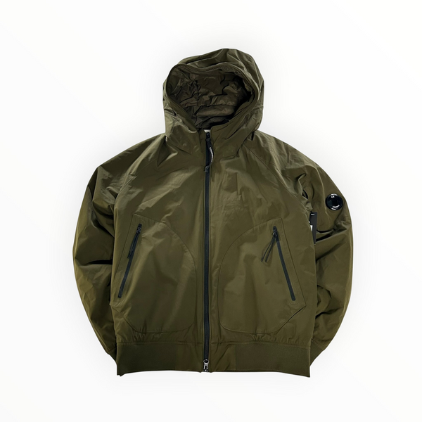 Secondstore C.P. Company hooded bomber jacket in khaki Pro-Tek fabric with signature sleeve lens and zip pockets.