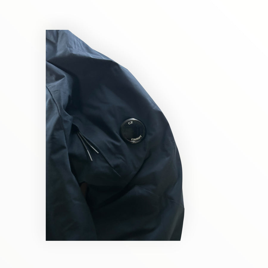 Secondstore navy C.P. Company Pro-Tek hooded jacket sleeve featuring the signature black lens detail