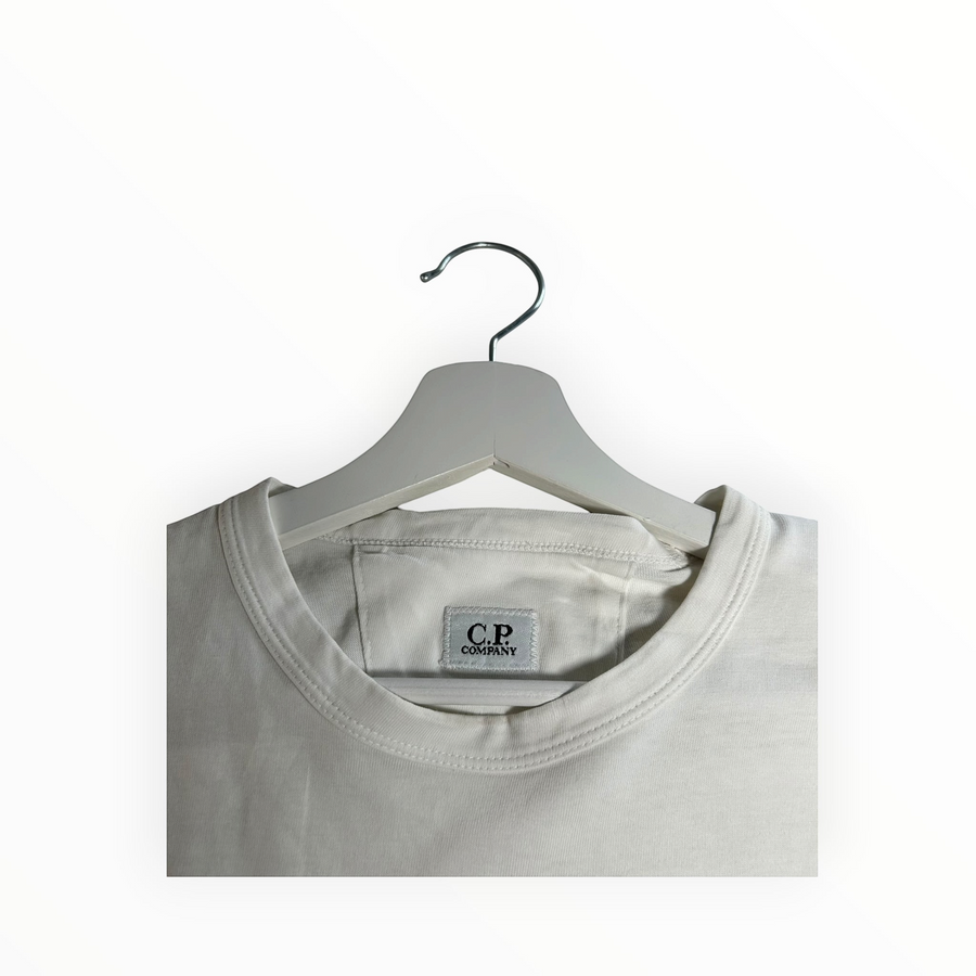Secondstore off-white C.P. Company cotton crew neck t-shirt with internal brand label detail on a white hanger
