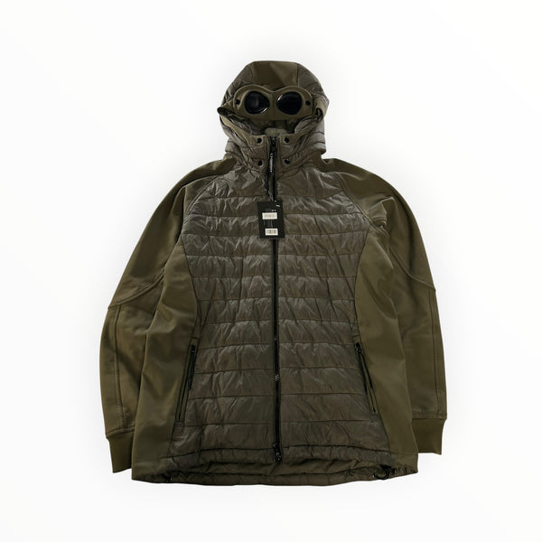 Secondstore C.P. Company olive green hybrid goggle jacket with quilted panels and integrated hood lenses.