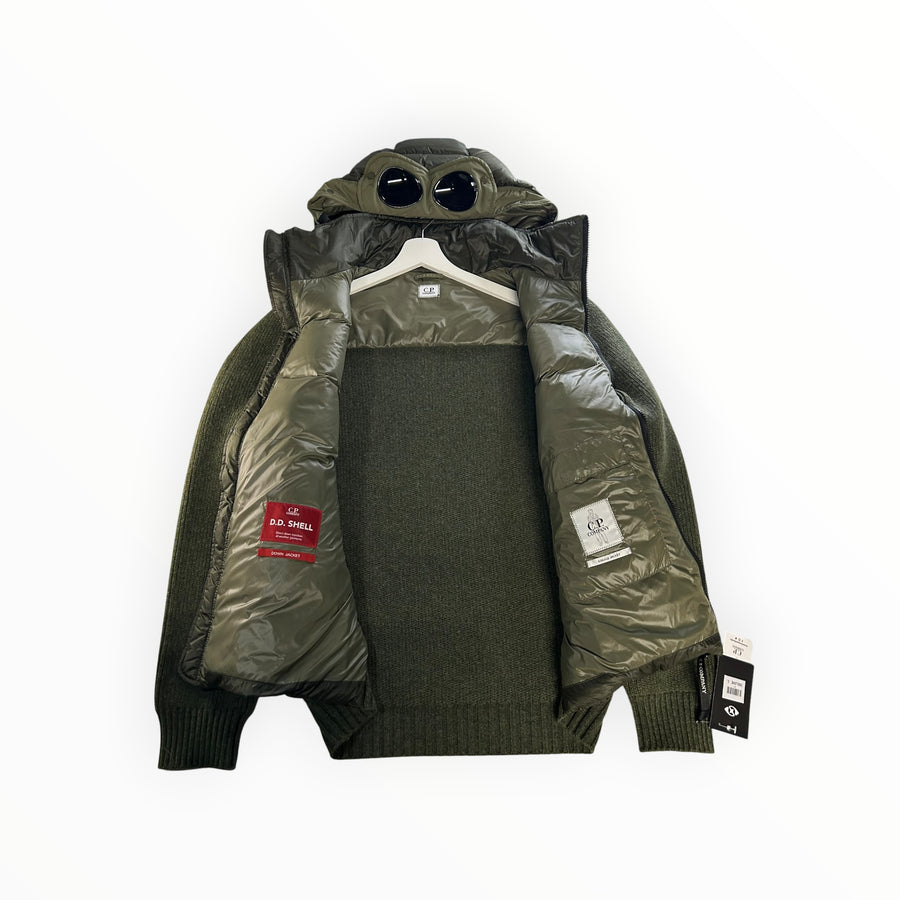 Secondstore C.P. Company olive green hybrid down jacket with signature goggle hood, quilted panels and knit sleeves.