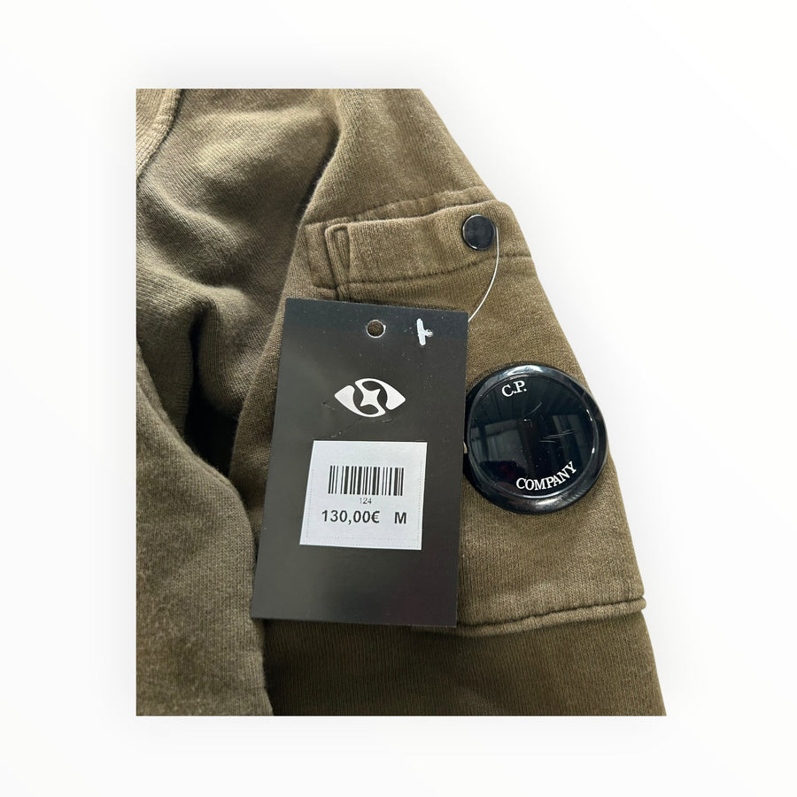 Secondstore olive-khaki C.P. Company cotton hooded sweatshirt featuring the iconic sleeve lens detail and brand tag.