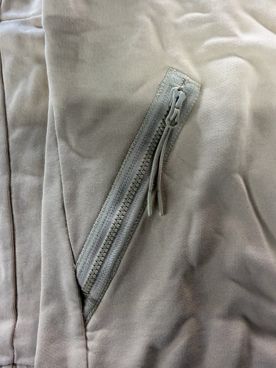 Gros plan sur la poche zippée beige d'un sweat-shirt en coton Secondstore C.P. Company avec tirette détaillée