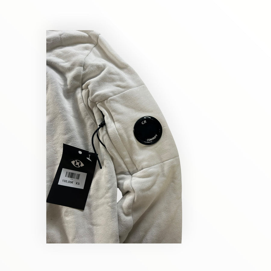 Secondstore C.P. Company off-white cotton sweatshirt sleeve featuring the iconic black lens pocket detail.