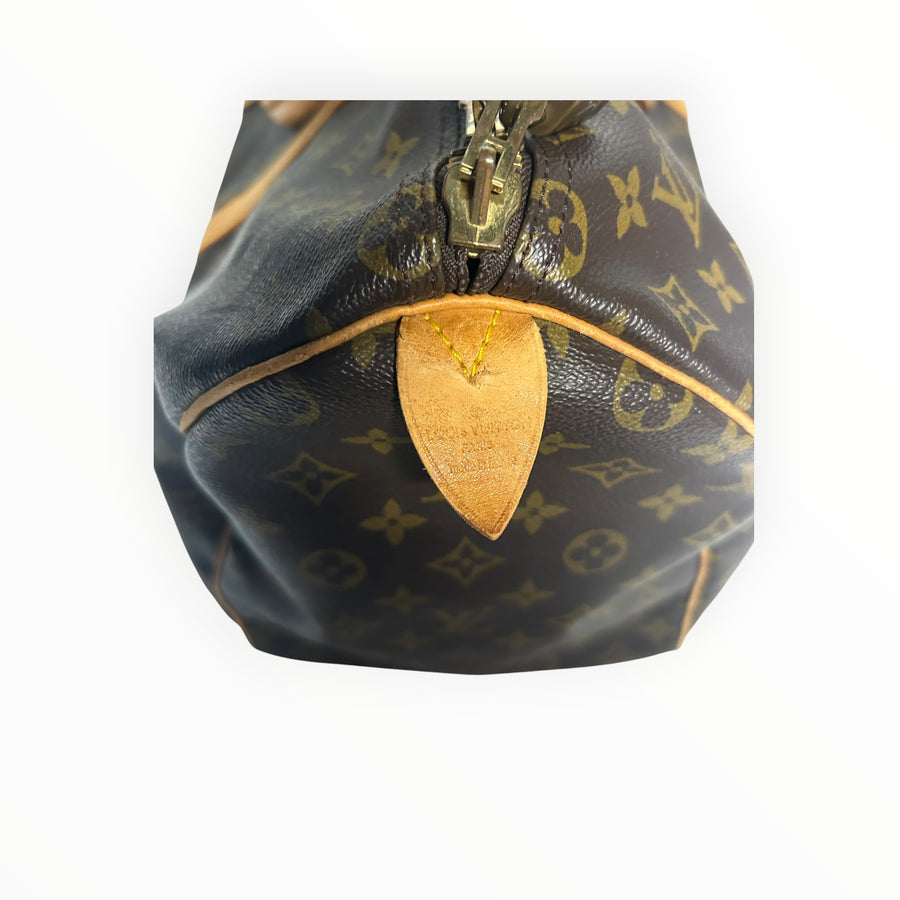 Détail de la fermeture éclair et de la languette en cuir du sac de voyage Secondstore Louis Vuitton Keepall en toile
