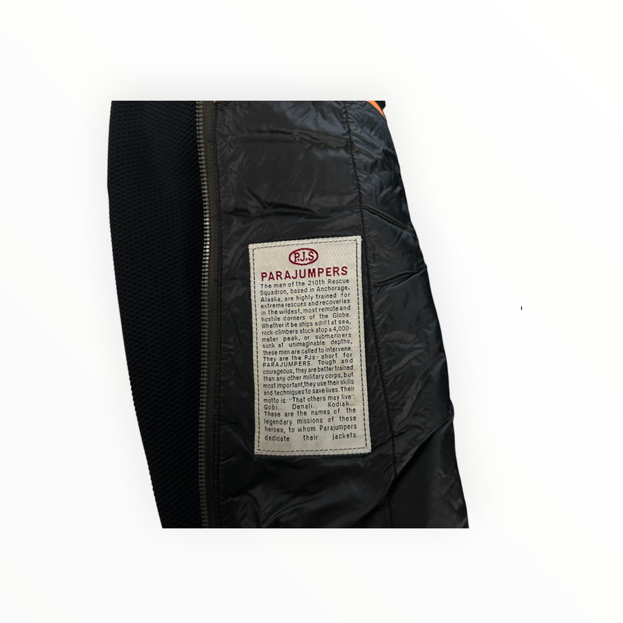 Secondstore Parajumpers hybrid jacket interior featuring the iconic brand story patch on black quilted nylon fabric.