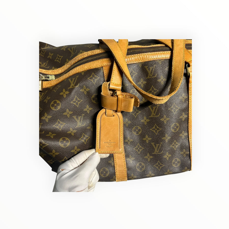 Sac de voyage Louis Vuitton Keepall en toile Monogram marron avec finitions en cuir naturel, vendu par Secondstore