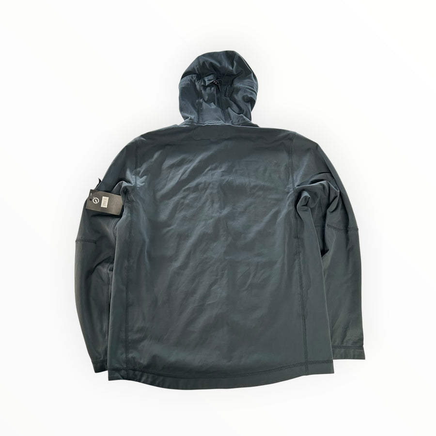 Back view of a Secondstore Stone Island light soft shell hooded jacket in dark grey with a sleeve compass badge.