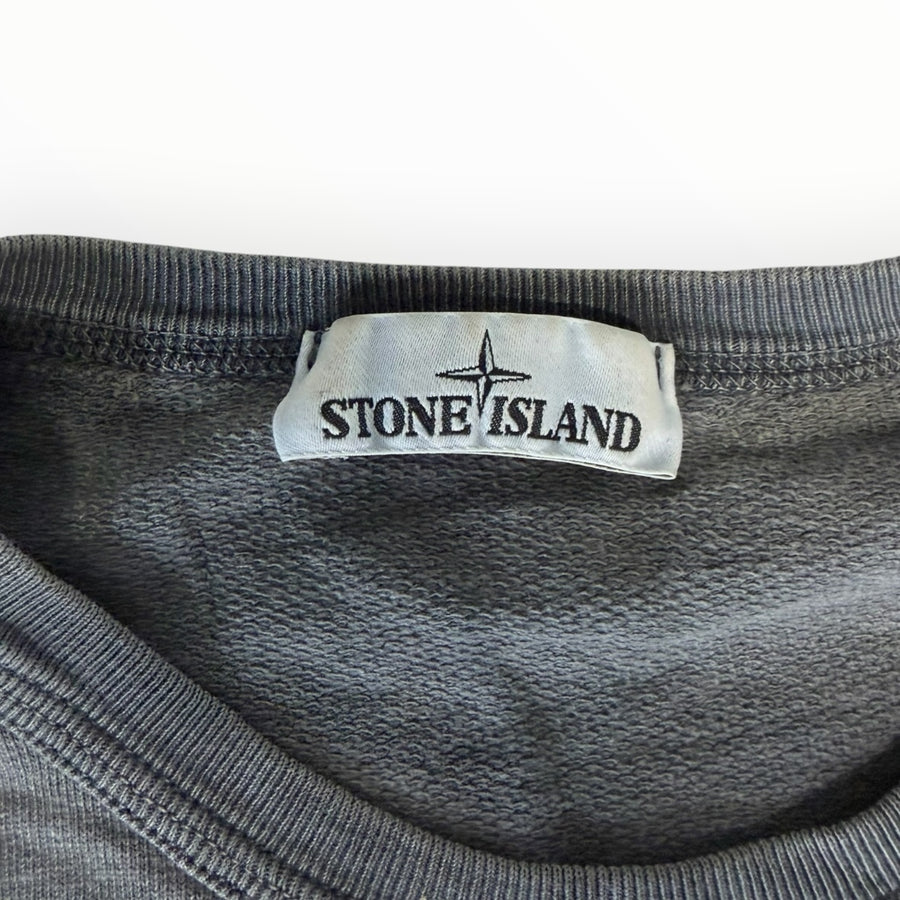 Gros plan sur l'étiquette de col d'un sweat-shirt Secondstore Stone Island en coton gris à col rond côtelé