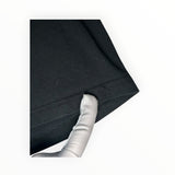 Secondstore black cotton t-shirt sleeve detail showing high-quality stitching and soft fabric texture