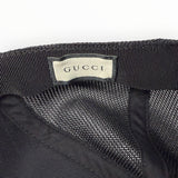 Étiquette intérieure de marque GUCCI sur une casquette noire en maille filet Secondstore