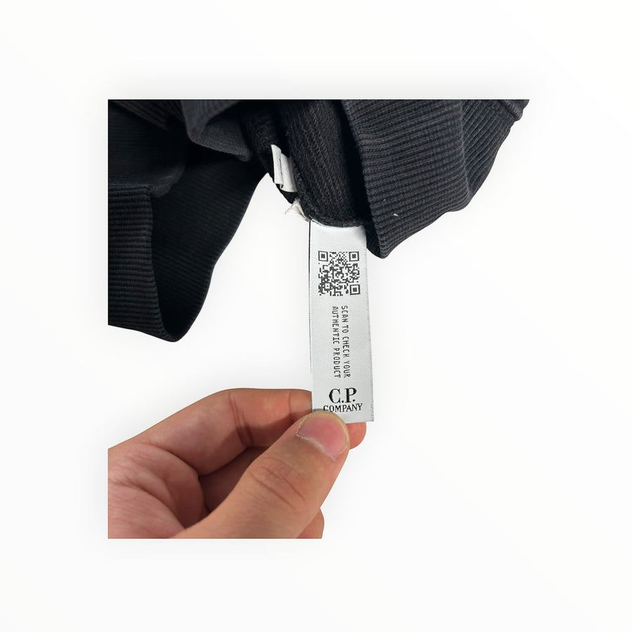 Secondstore C.P. Company black cotton sweatshirt showing the internal authenticity tag with QR code and brand logo