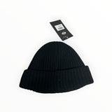 Secondstore C.P. Company black ribbed wool beanie hat with a turn-up hem and attached brand price tag.