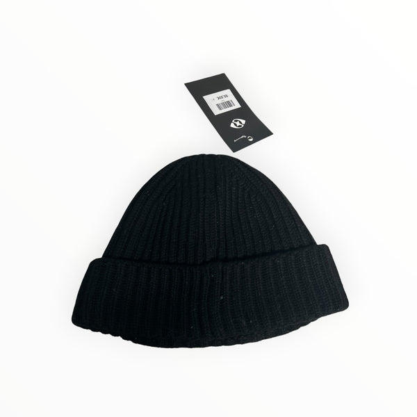 Secondstore C.P. Company black ribbed wool beanie hat with a turn-up hem and attached brand price tag.