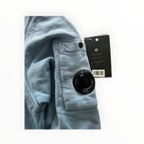 Secondstore C.P. Company blue cotton crewneck sweatshirt featuring the iconic sleeve utility pocket and lens detail.