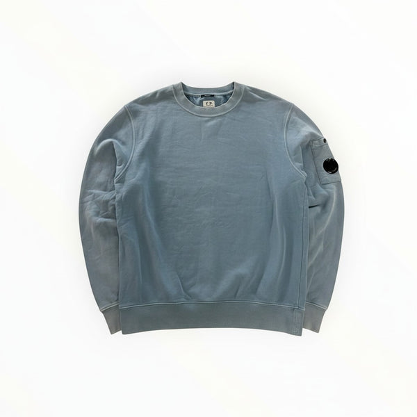 Secondstore C.P. Company light blue cotton crewneck sweatshirt with signature lens detail on the left sleeve.