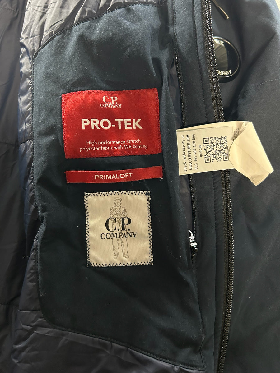 Interior labels of a navy Secondstore C.P. Company Pro-Tek jacket featuring Primaloft insulation and authenticity tag.