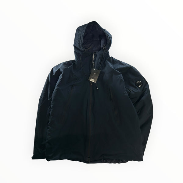 Secondstore C.P. Company navy blue Pro-Tek hooded jacket with signature sleeve lens and zip front closure.