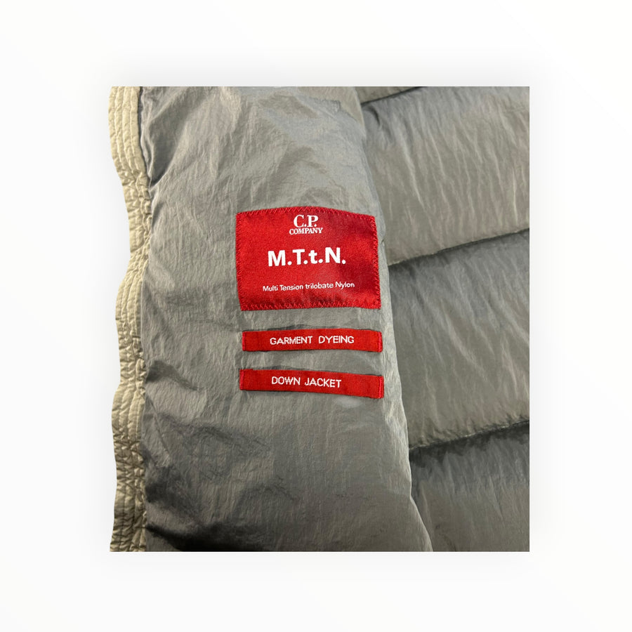 Secondstore C.P. Company padded down vest interior showing red M.T.t.N. nylon fabric labels and quilted texture