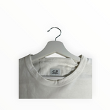 Secondstore off-white C.P. Company cotton crew neck t-shirt with internal brand label detail on a white hanger