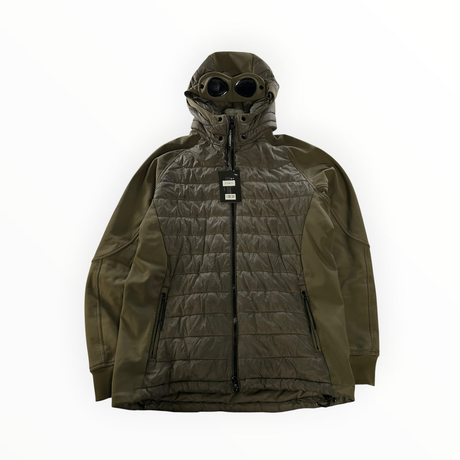 Secondstore C.P. Company olive green hybrid goggle jacket with quilted panels and integrated hood lenses.