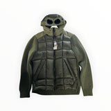 Secondstore C.P. Company olive green hybrid down jacket with signature goggle hood and quilted knit sleeves.