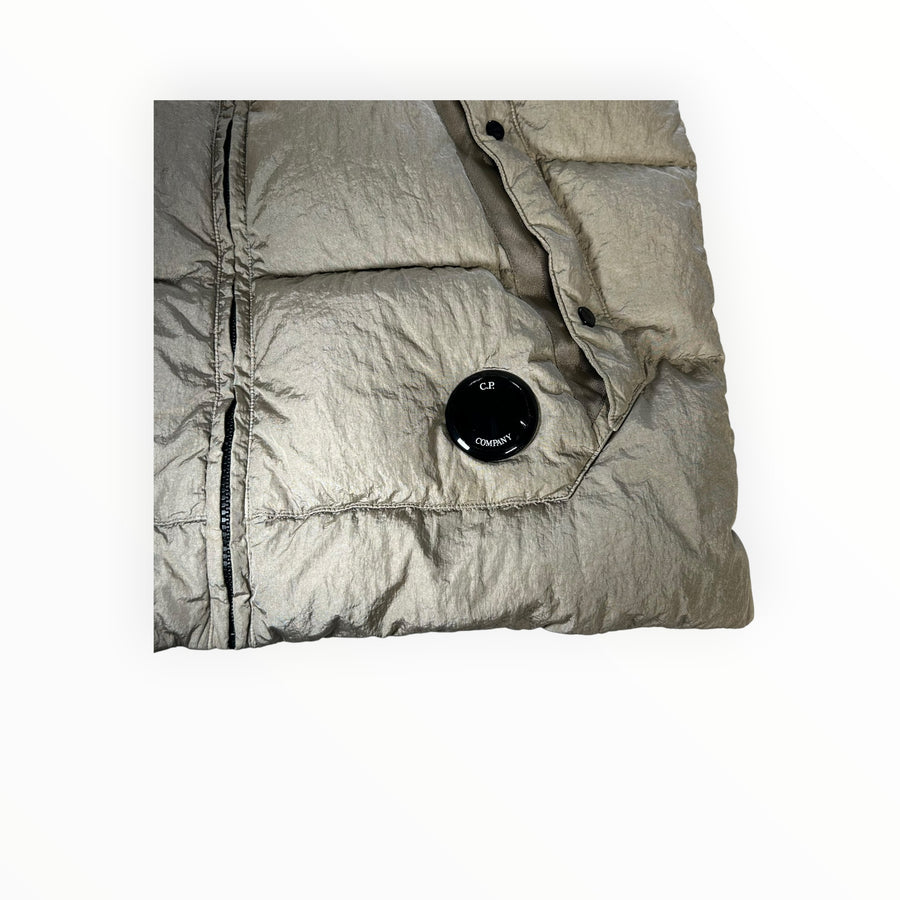 Secondstore C.P. Company padded down vest in iridescent beige nylon with iconic lens detail on the front pocket.