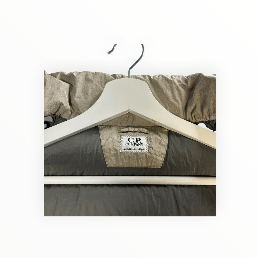Secondstore C.P. Company padded down vest in iridescent grey nylon with internal brand label on a white hanger
