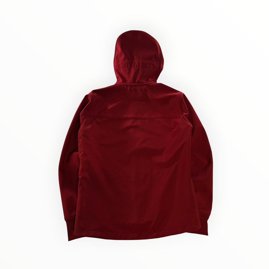 Secondstore C.P. Company red soft-shell Goggle Jacket seen from the back with a hood and technical fabric construction.