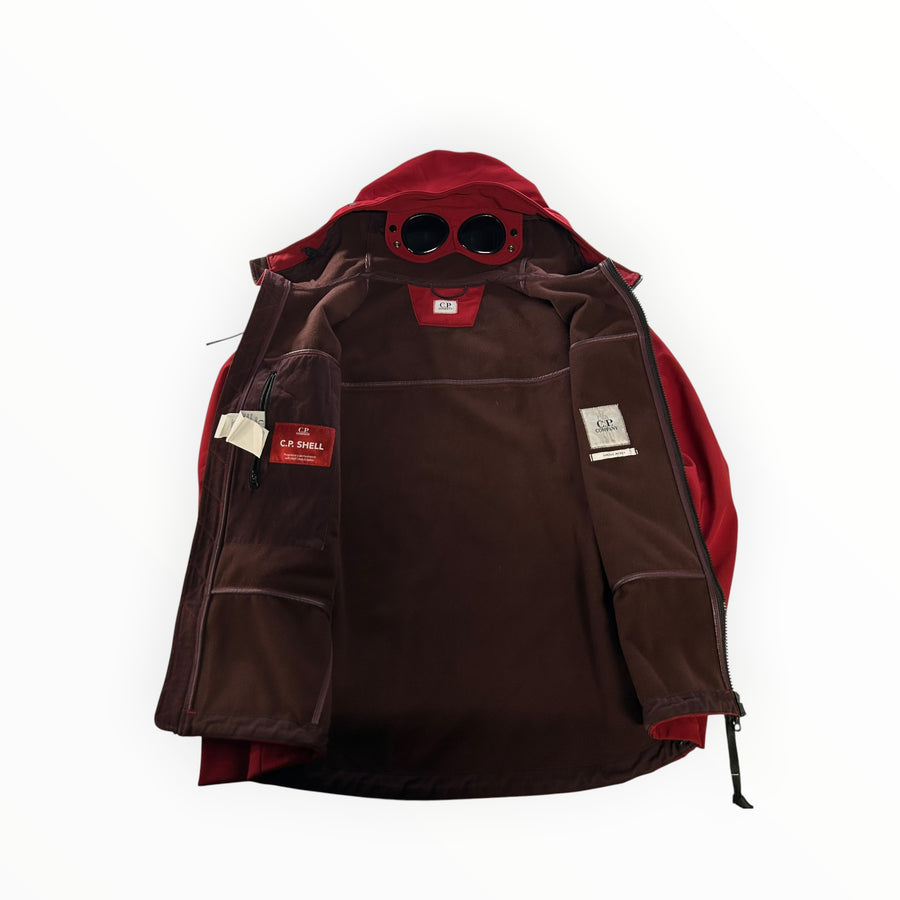 Secondstore red C.P. Company Goggle Jacket in CP Shell fabric with integrated hood goggles and brown fleece lining.