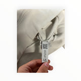 Secondstore C.P. Company off-white cotton sweatshirt showing the internal authenticity label and QR code tag