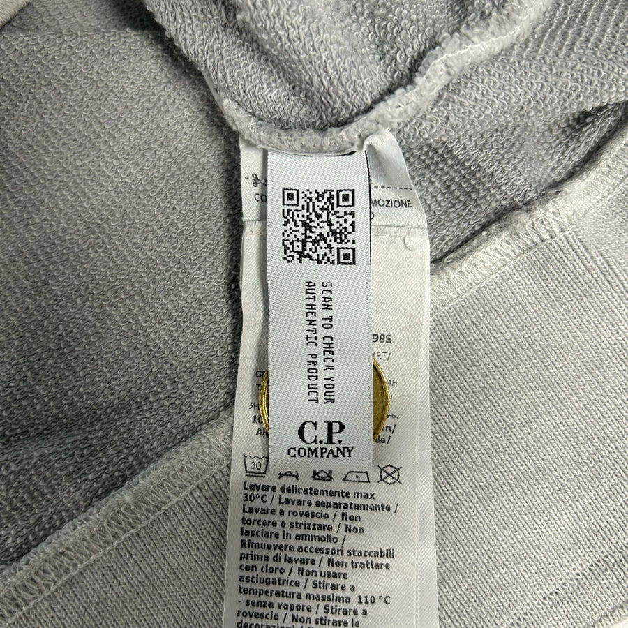 Secondstore C.P. Company sweatshirt internal care label with authenticity QR code and branding on grey cotton fabric