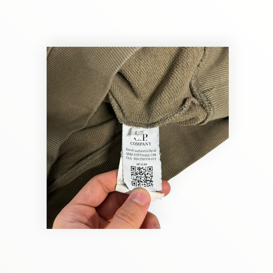 Secondstore C.P. Company sweatshirt interior label with authenticity QR code and branding on olive-khaki cotton fabric