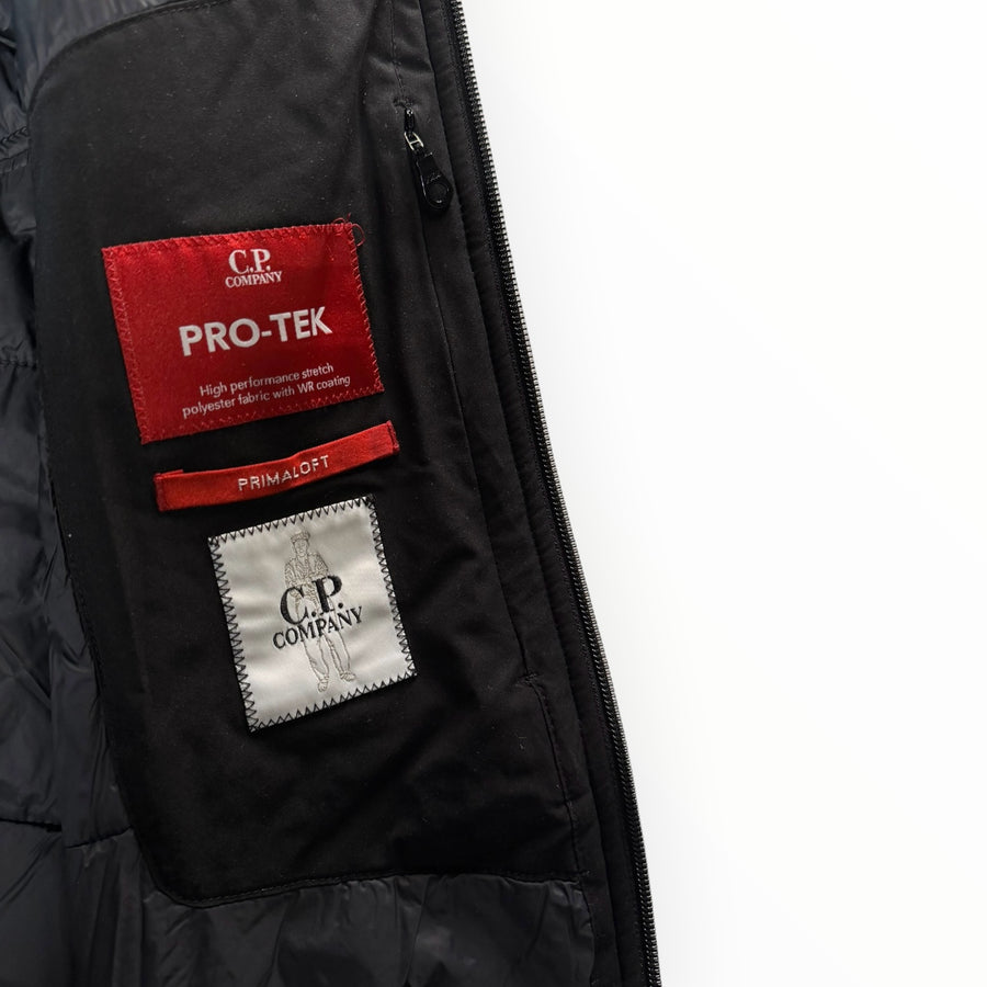 Détail intérieur d'une veste Secondstore C.P. Company avec étiquettes Pro-Tek et Primaloft sur tissu noir