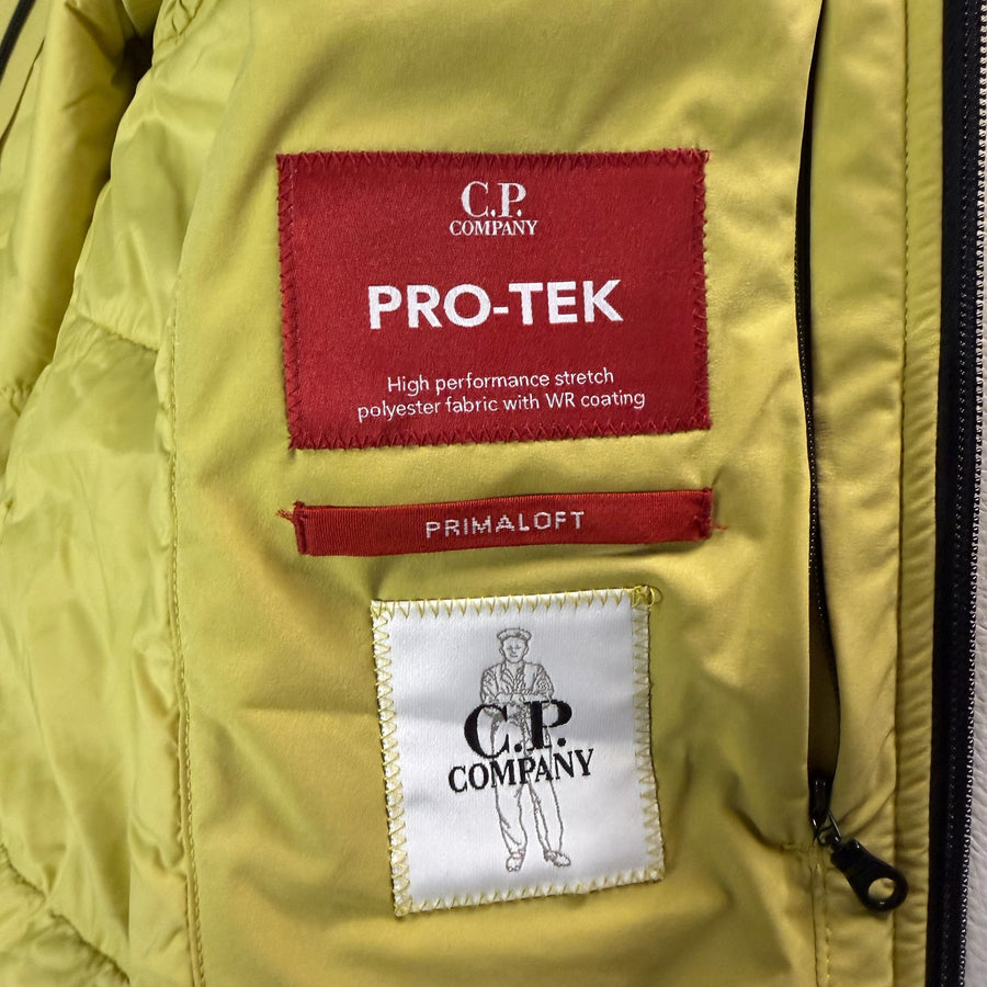Étiquettes intérieures Secondstore sur veste jaune C.P. Company avec détails Pro-Tek et isolation PrimaLoft