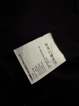 Étiquette de composition Secondstore sur un cardigan noir en maille Comme des Garçons fabriqué au Royaume-Uni