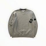 Secondstore grey C.P. Company crewneck sweatshirt in cotton with ribbed trim and iconic sleeve lens detail.