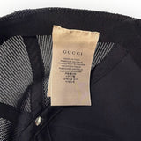 Étiquette intérieure de casquette Secondstore GUCCI indiquant Made in Italy sur fond de maille noire respirante
