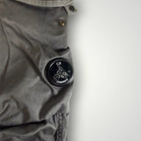 Gros plan sur le badge emblématique C.P. Company sur un pantalon cargo gris en coton de la boutique Secondstore