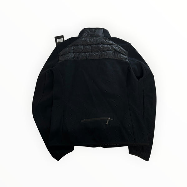 Back view of a black Secondstore Parajumpers hybrid jacket featuring quilted nylon panels and textured knit fabric.