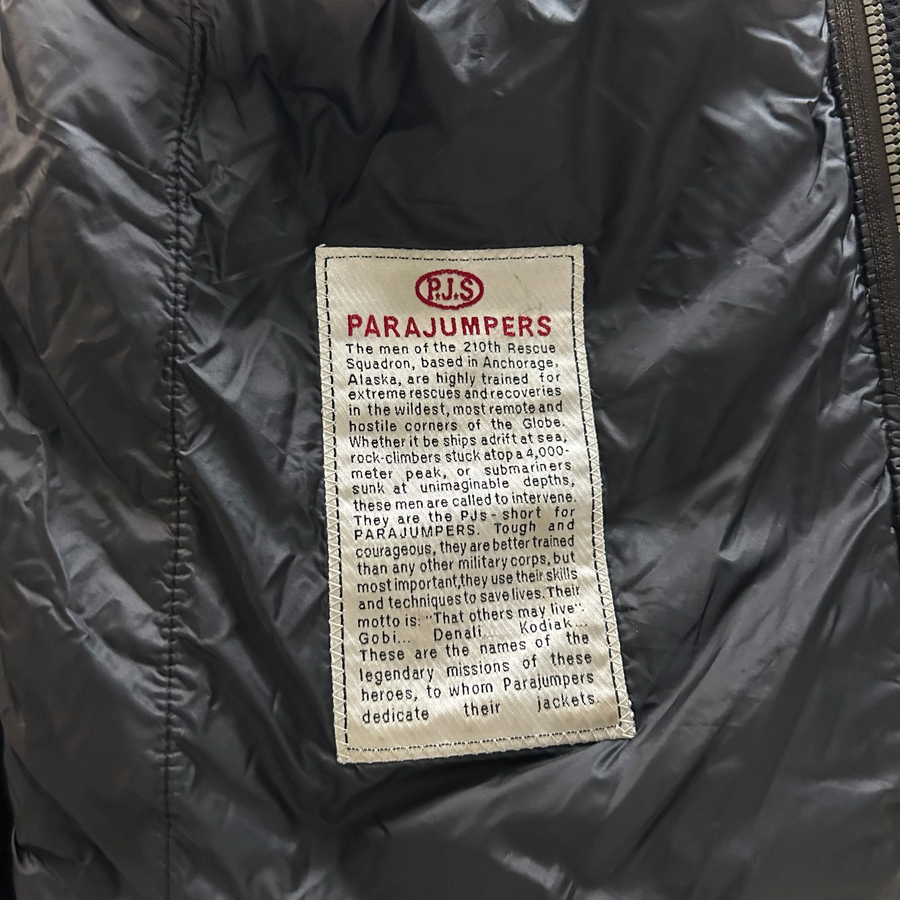 Secondstore PARAJUMPERS Warm Up Hybrid jacket interior label detailing the brand's rescue mission heritage.
