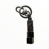 Porte-clés Secondstore Louis Vuitton en métal argenté sombre avec design géométrique de cubes gravés et mousqueton