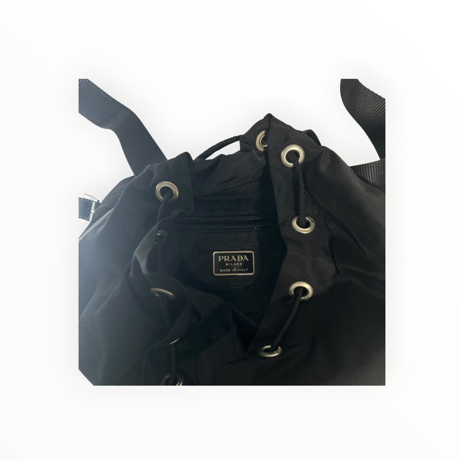 Intérieur du sac à dos Secondstore Prada en nylon noir avec logo métallique et cordon de serrage