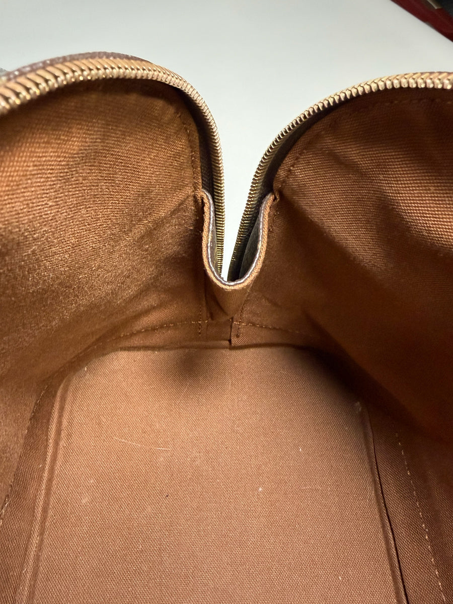 Intérieur spacieux en textile marron du sac à main Secondstore Louis Vuitton Alma avec fermeture éclair dorée