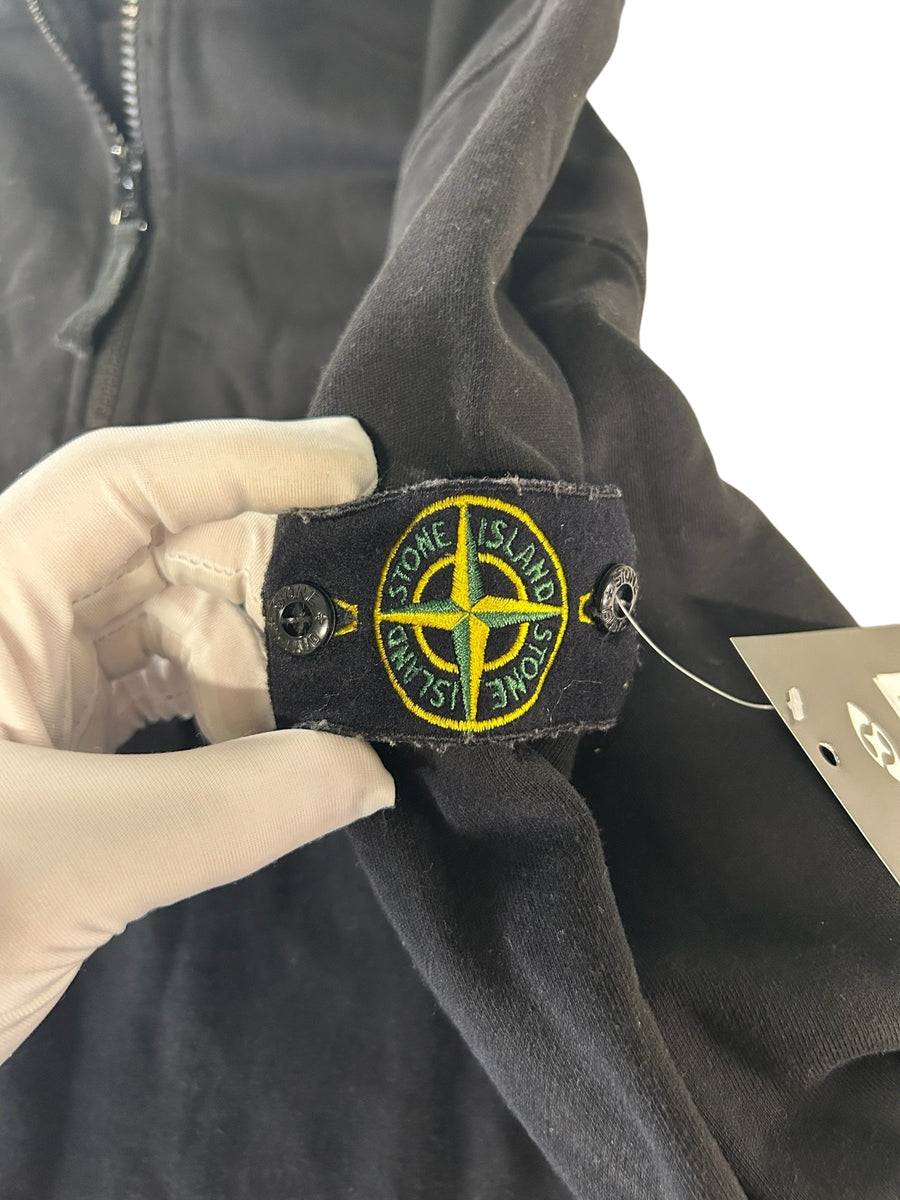 Secondstore Stone Island black cotton sweatshirt sleeve featuring the iconic yellow and green compass badge